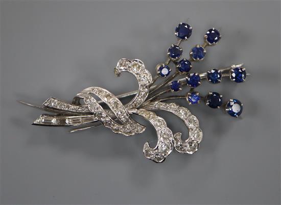 A white metal, sapphire and diamond set floral spray brooch, 48mm.